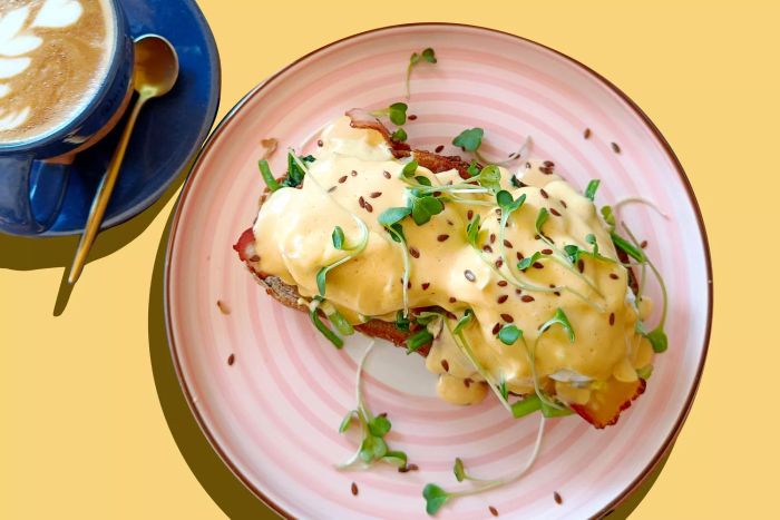 Eggs Benedict paired with a cappuccino