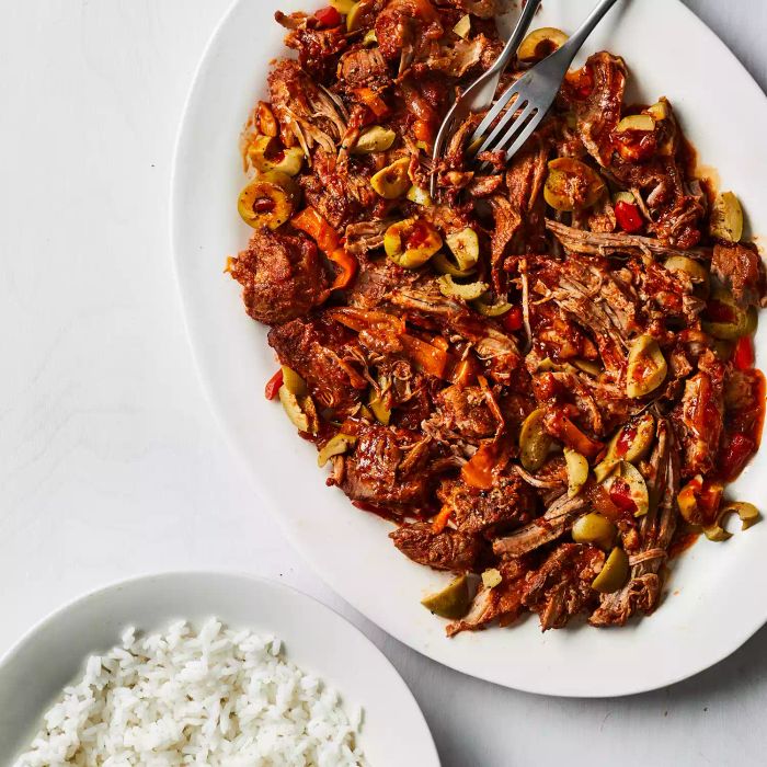 Pork cooked in a slow cooker with peppers and olives offers a savory and comforting meal that is as easy to prepare as it is delicious.