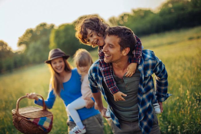 Photo of a cheerful family enjoying a picnic outdoors