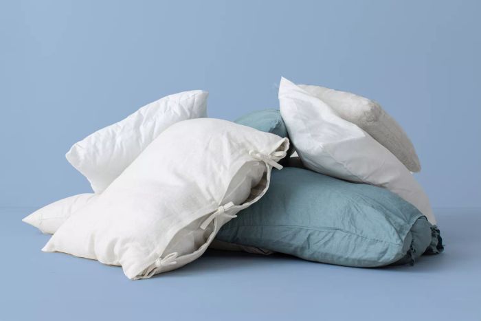 old pillows against a blue backdrop
