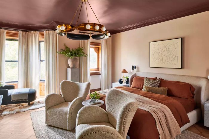 A generously sized urban bedroom filled with abundant natural light
