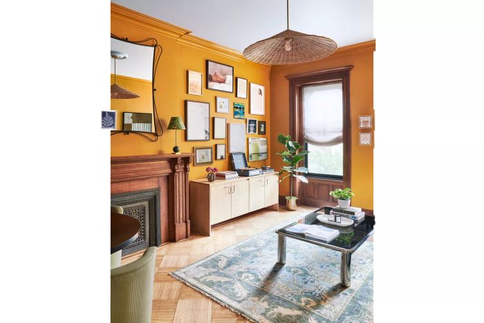 A mix of Victorian and modern styles, this space highlights two focal points: the classic fireplace and the eclectic gallery wall above the console.