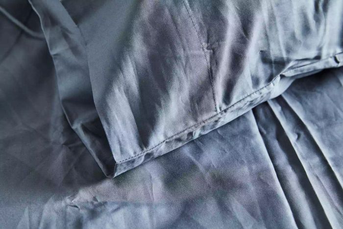 A close-up of the stitching on the pillowcase of the Sijo Home Organic Percale Cotton CrispCool Sheet Set