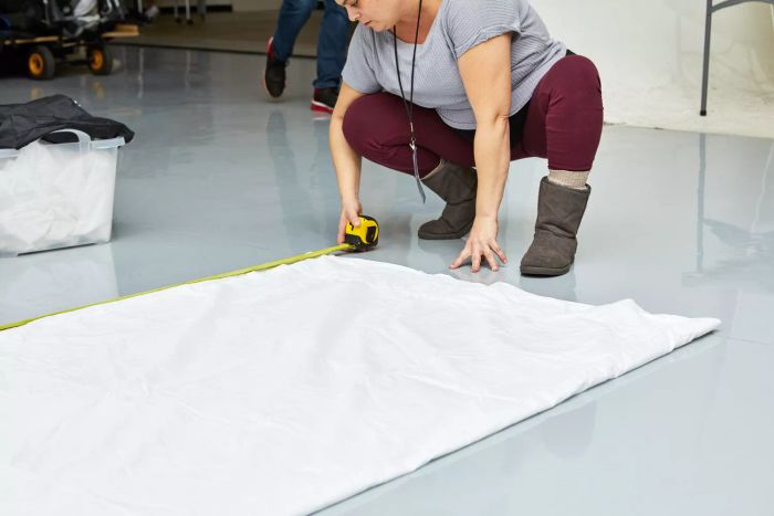 Person measuring a Boll & Branch Signature Hemmed Sheet