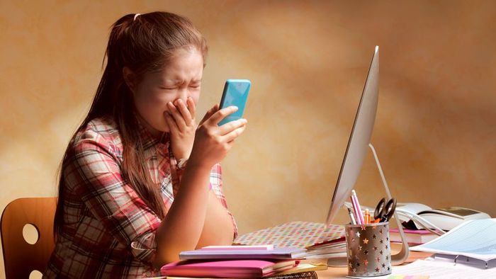 A teenager suffering from bullying via smartphone.