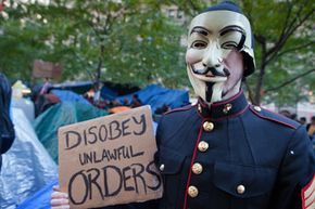 A protester from the Occupy Wall Street movement stands in Zuccotti Park on October 30, 2011, the day after a nor'easter storm blanketed the area with snow.
