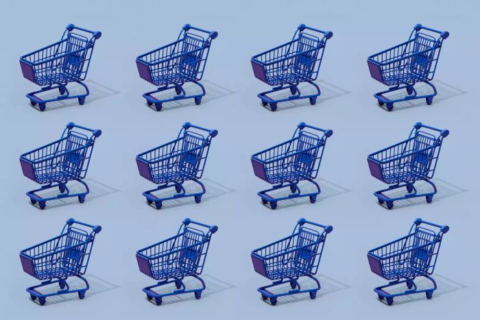 a collection of blue shopping carts against a blue backdrop