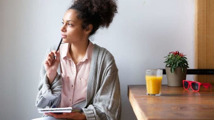 This woman follows a systematic routine of drinking orange juice whenever she feels inspired.