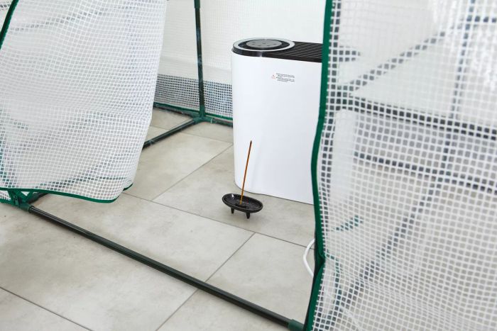 An incense stick is seen burning in front of the Aroeve MK04 Air Purifier.