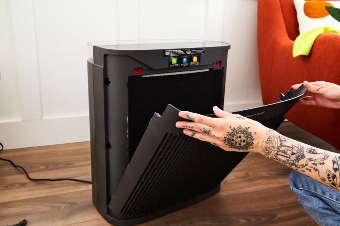 A person detaching the front panel from the Honeywell HPA5300 InSight HEPA Air Purifier.