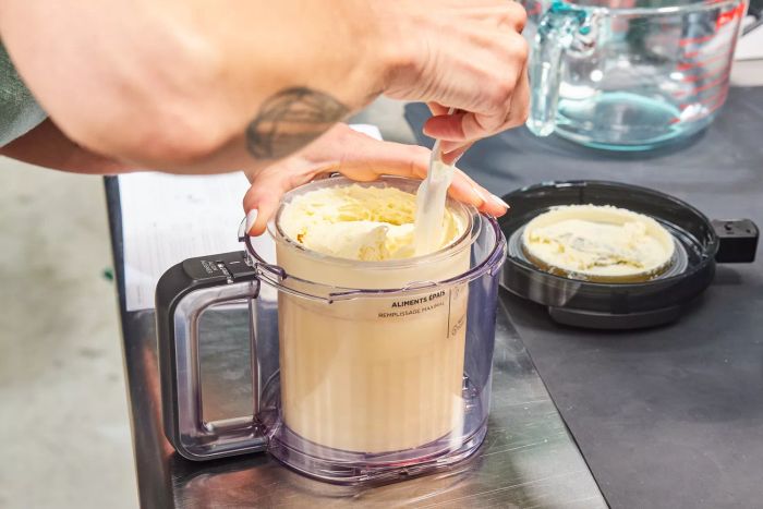 Close-up of a person mixing ice cream in the Ninja Creami Deluxe 11-in-1 XL Ice Cream Maker