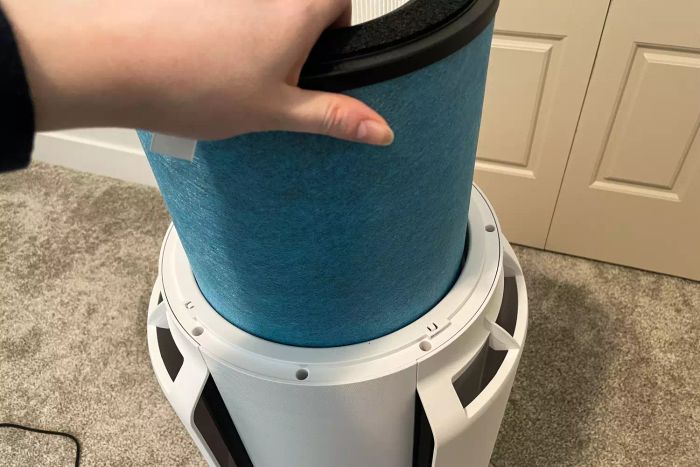 A person inserts a filter into the Shark NeverChange Air Purifier MAX.