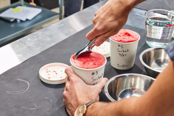 A person scooping sorbet made with the Cuisinart 1.5-Quart Frozen Yogurt, Ice Cream, & Sorbet Maker from a carton
