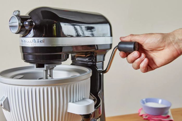 A person adjusting the KitchenAid Ice Cream Maker Attachment