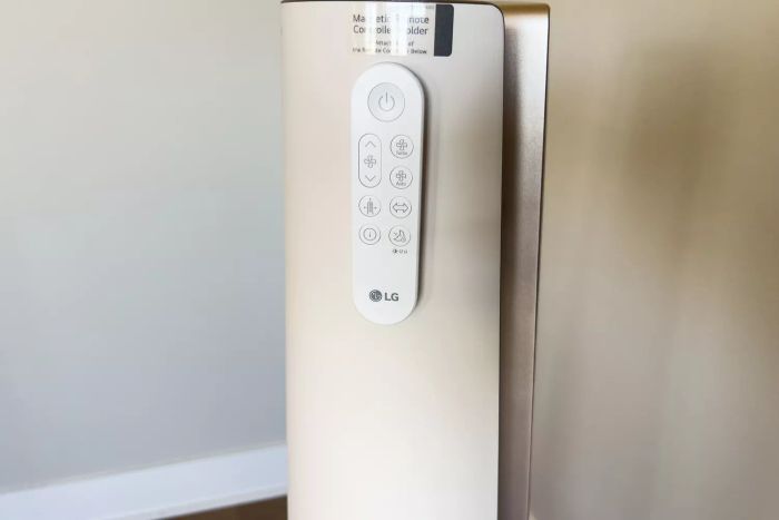 The remote control is conveniently attached to the side of the LG PuriCare AeroTower True HEPA Air Purifying Fan for easy access and operation.