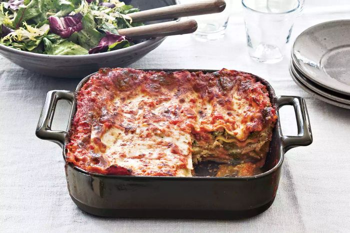 Broccoli, spinach, and three-cheese lasagna in a baking dish.