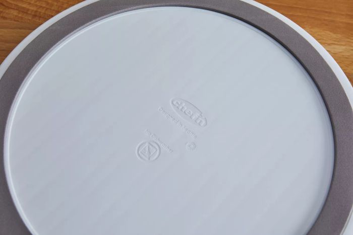 A close-up view of the Chef'n Sweet Spot Ice Cream Maker resting on a wooden surface.