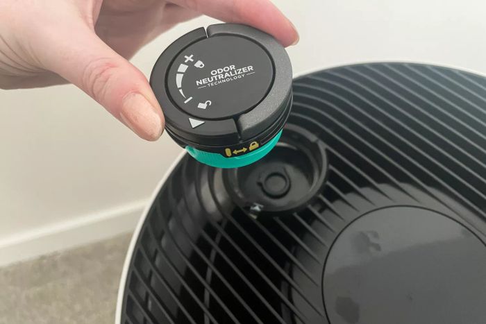 A person attaches the odor neutralizer to the Shark NeverChange Air Purifier MAX.