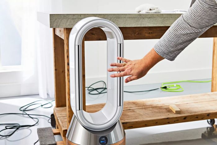 A person holding their hand in front of the Dyson Purifier Humidify+Cool Formaldehyde PH04.
