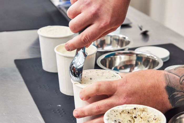 Person serving scoops of ice cream made in the Breville The Smart Scoop Ice Cream Maker