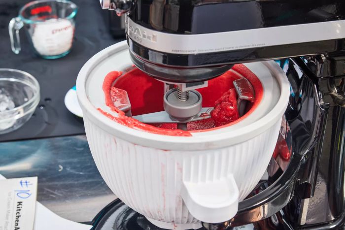 Close-up shot of the KitchenAid Ice Cream Maker Attachment churning vibrant red sorbet