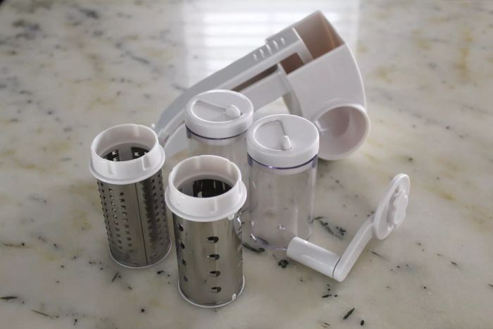 Vivant Rotary Grater resting on a counter with its accessories