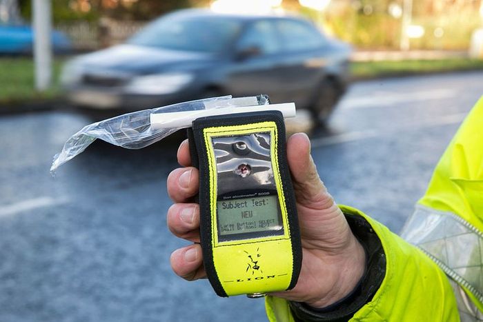 A Belfast police officer holds an operational breathalyzer in Northern Ireland