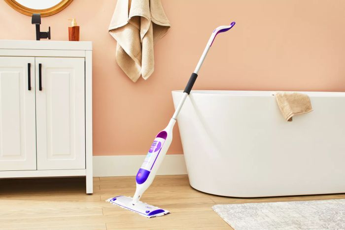 Swiffer PowerMop Multi-Surface Kit resting against a bathtub for easy access