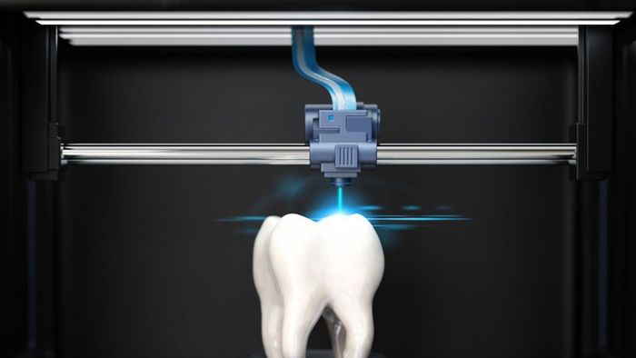 A 3D printer crafting a tooth model.