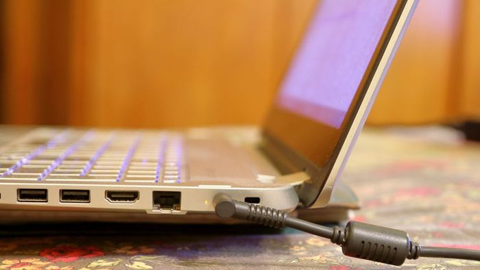 The laptop is connected to the power supply.