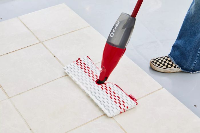 foot next to O-Cedar ProMist MAX Microfiber Spray Mop mopping tile floor