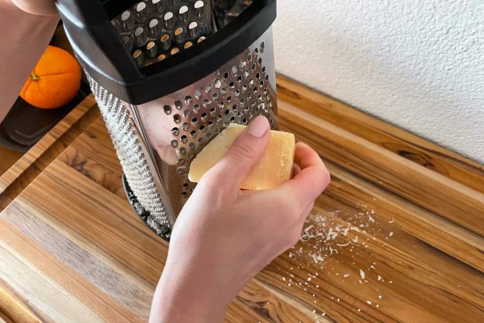 Person grating cheese on the KitchenAid Gourmet Box Grater
