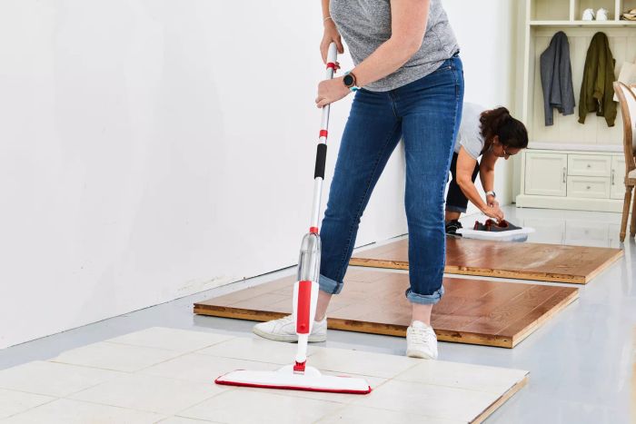 individual cleaning tile floor using the Panda Grip Microfiber Spray Mop