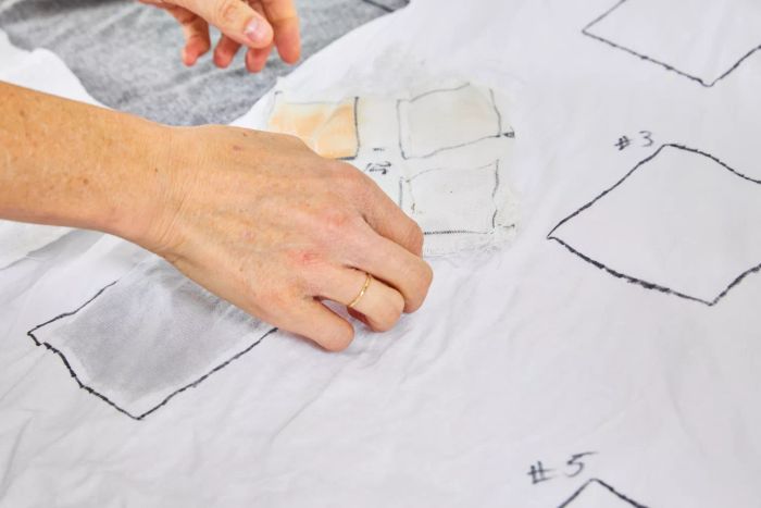 Hand inspecting stained fabric