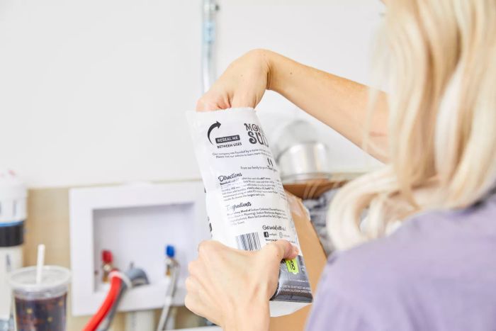 Holding a bag of Molly's Suds Unscented Laundry Detergent Powder