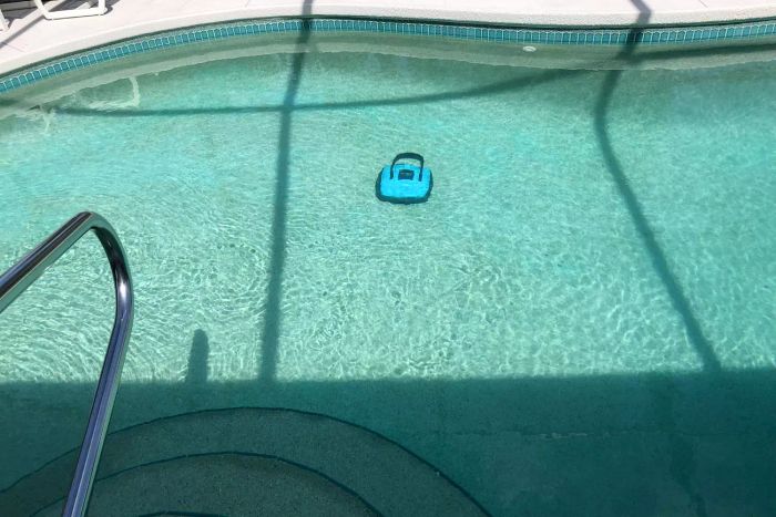 The WYBOT Cordless Robotic Pool Cleaner sitting at the bottom of the pool.