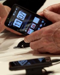 A visitor checks out an HTC smartphone at the Vodafone booth during the CeBIT Technology Fair on March 3, 2010, in Hannover, Germany.