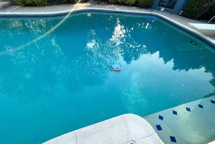 Dolphin Explorer E50 Robotic Pool Cleaner in action, cleaning a pool