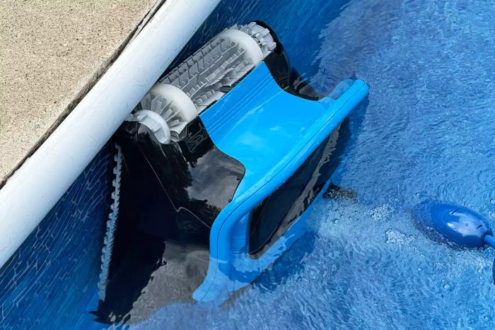 Dolphin Nautilus CC Plus Robotic Pool Cleaner in action, cleaning the side of a pool