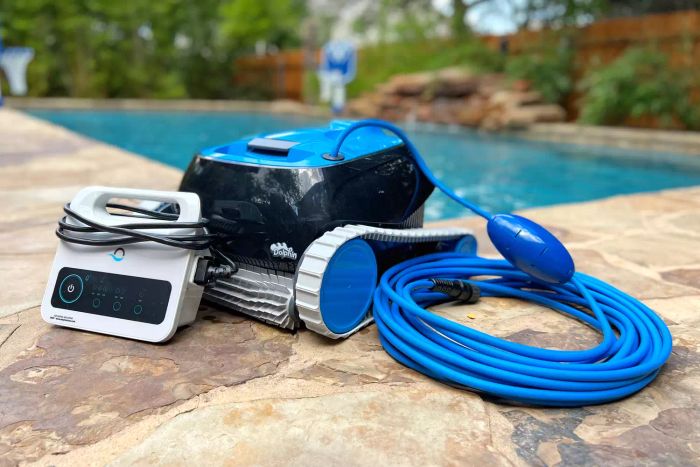 The Dolphin Nautilus CC Automatic Robotic Pool Vacuum Cleaner shown next to a pool