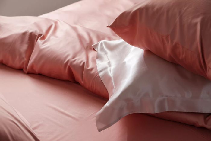 Close-up shot of a bed adorned with luxurious silk bedding