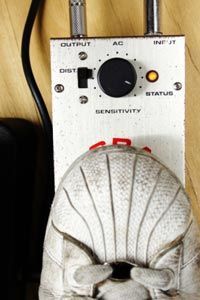 Foot pressing down on a guitar pedal.