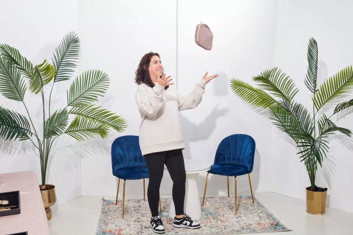 A person tossing the Bagsmart Jewelry Organizer Bag into the air