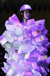 A model is wearing a designer dress that incorporates smart technology.