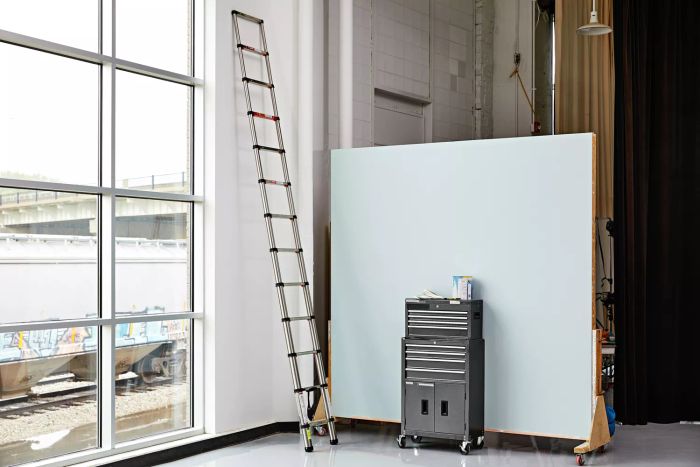 Meanfun Stainless Steel Telescoping Ladder extended on wall in large room