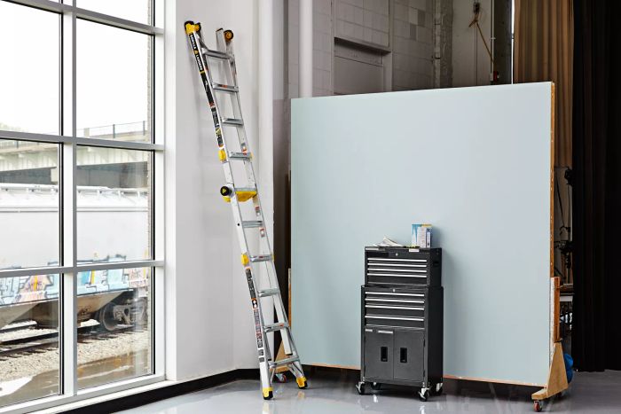 Gorilla Ladders 19-Foot Reach MPXT Multi-Position Ladder with Project Top displayed leaning against the wall near a window
