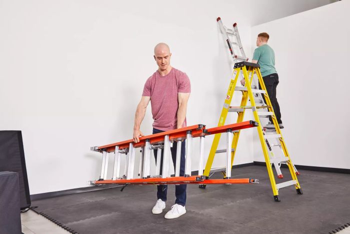 A person unfolding a ladder