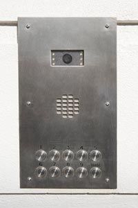 The type of security camera system a person chooses, like this compact camera inside an intercom, depends on the specific activity being monitored.