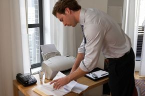 A person operating a fax machine
