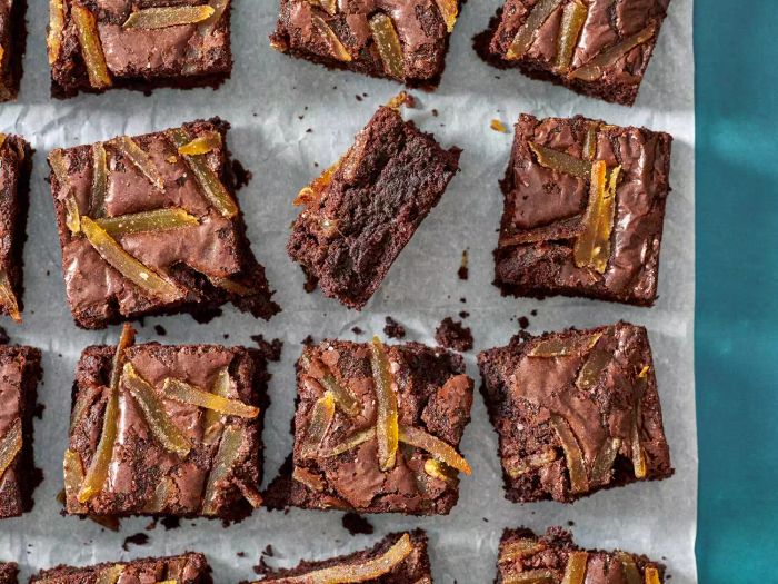 Ginger spiced brownies arranged on a piece of parchment paper.